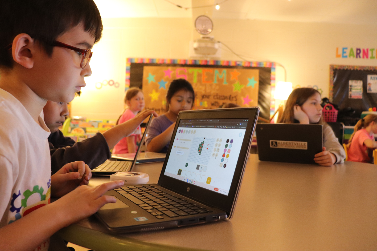 students presenting to the class infront of a Clevertouch IMPACT interactive display