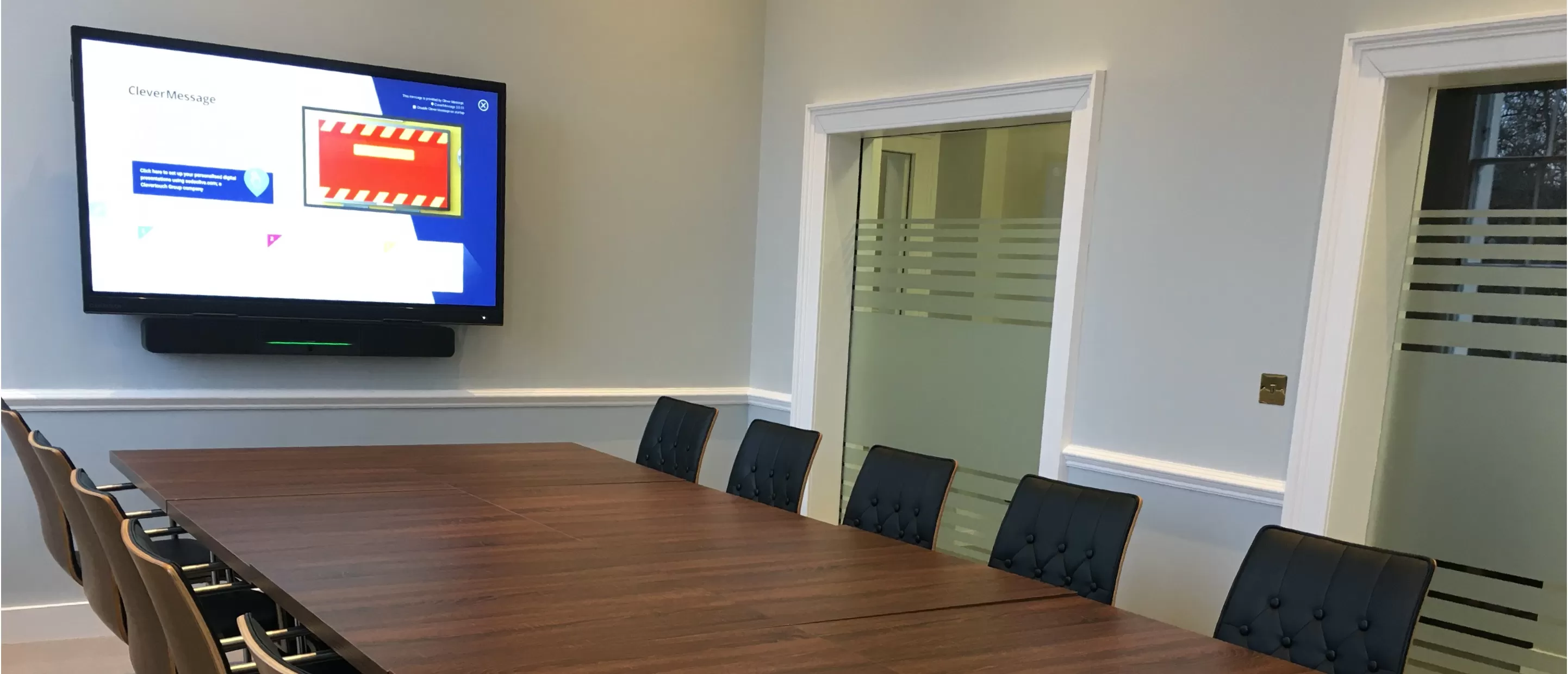 a Clevertouch UX Pro screen in a medium sized meeting room