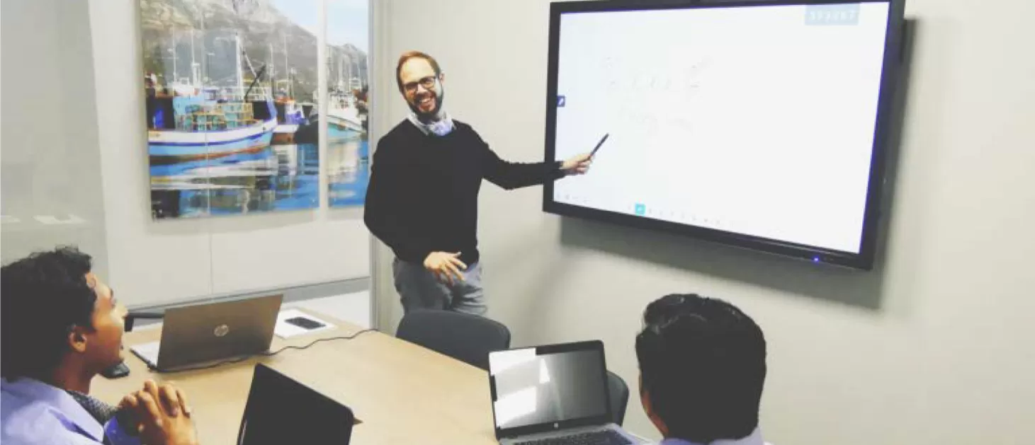 Clevertouch UX Pro in a small meeting room with people in