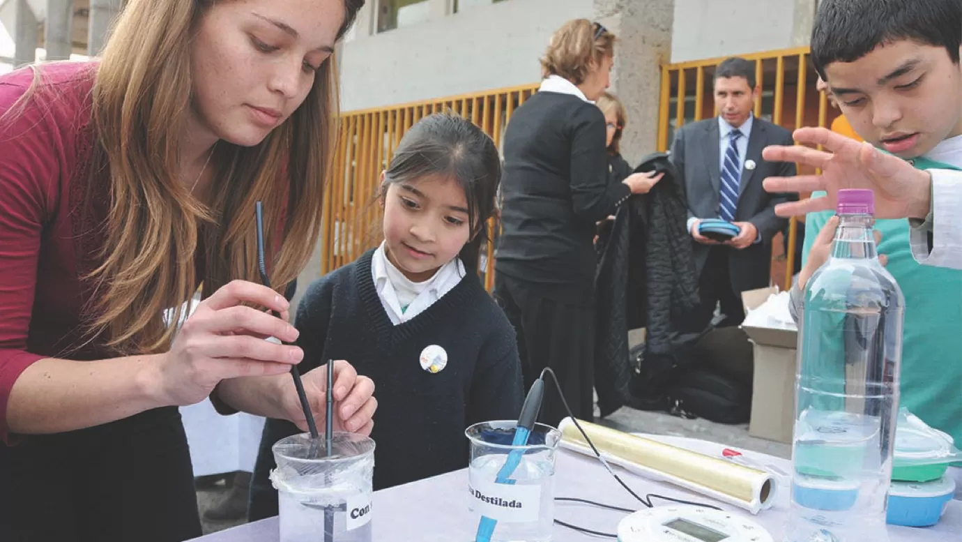 teachers helping students conduct a chemistry experiment