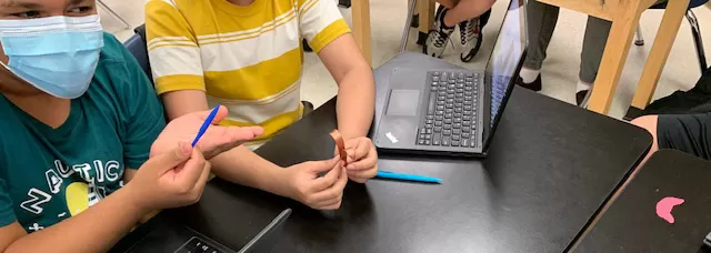 students holding 3D printed objects