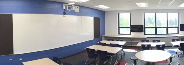 a MimioProjector™ touch projector in an empty classroom facing a huge whiteboard