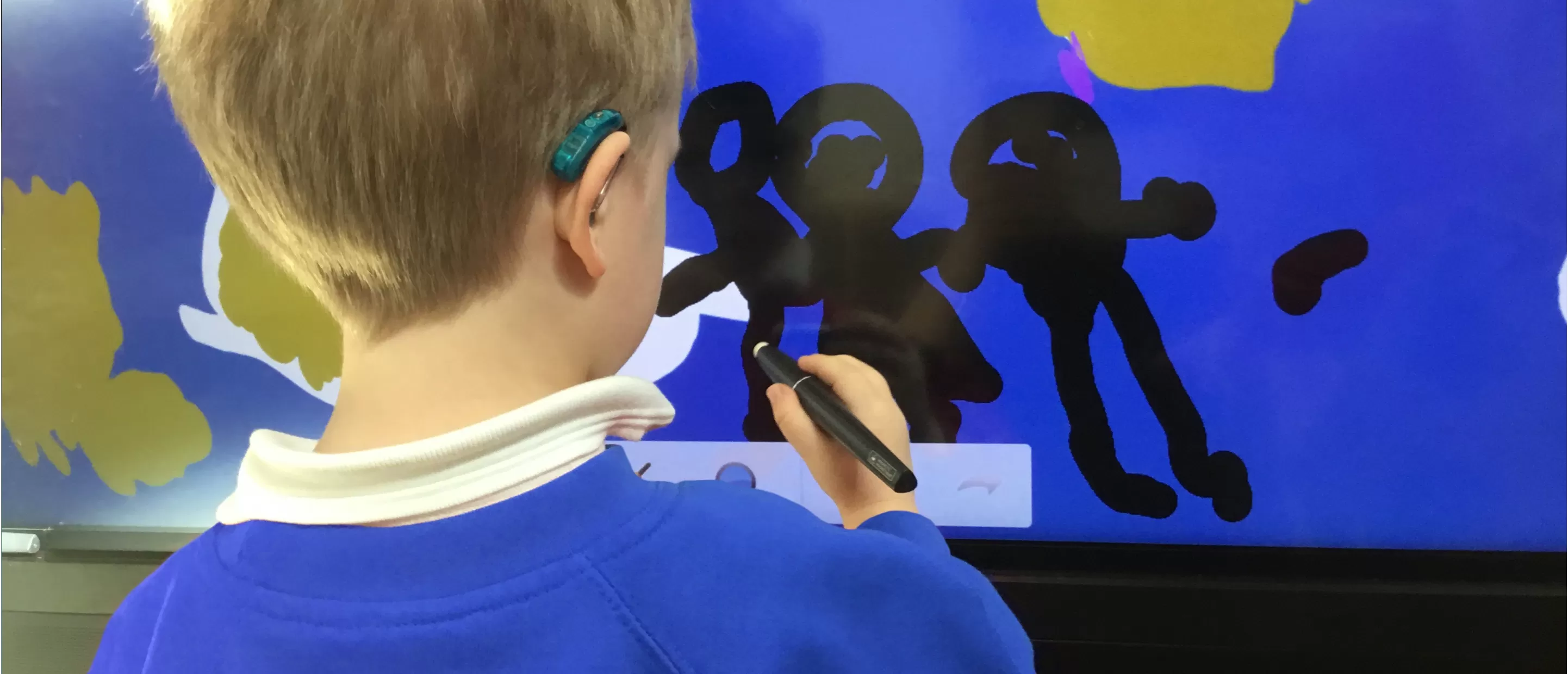 Student with a hearing aid using a Clevertouch IMPACT Plus