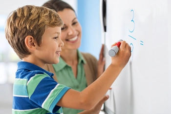 teacher helping student use mimio studio