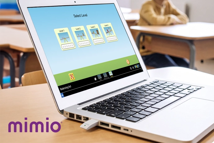 Laptop showing mimio studio with a class in the back ground and 'mimio' in the bottom right corner