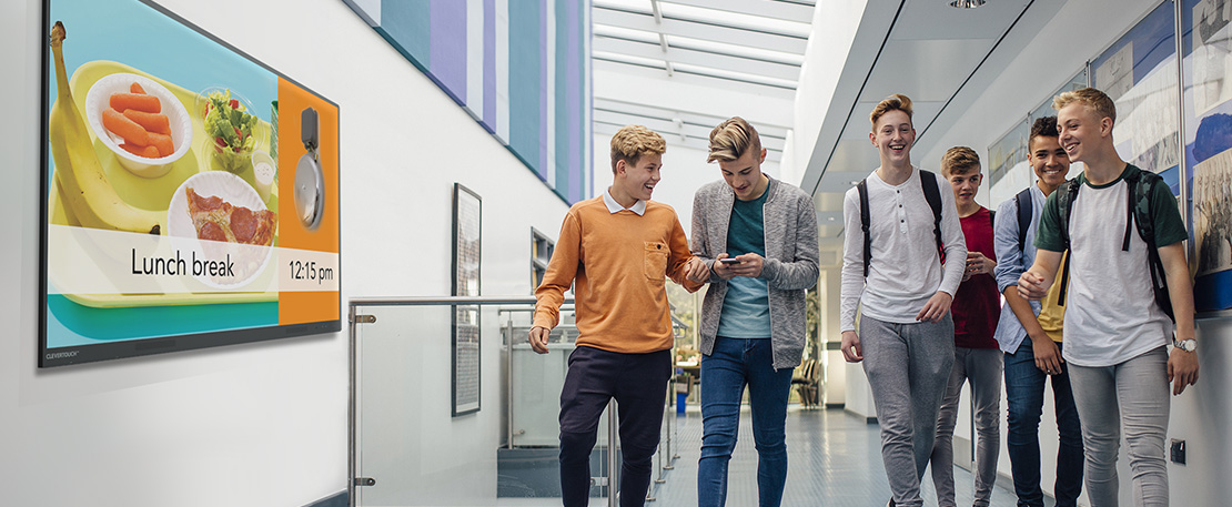 A teacher looking at a group of students' work