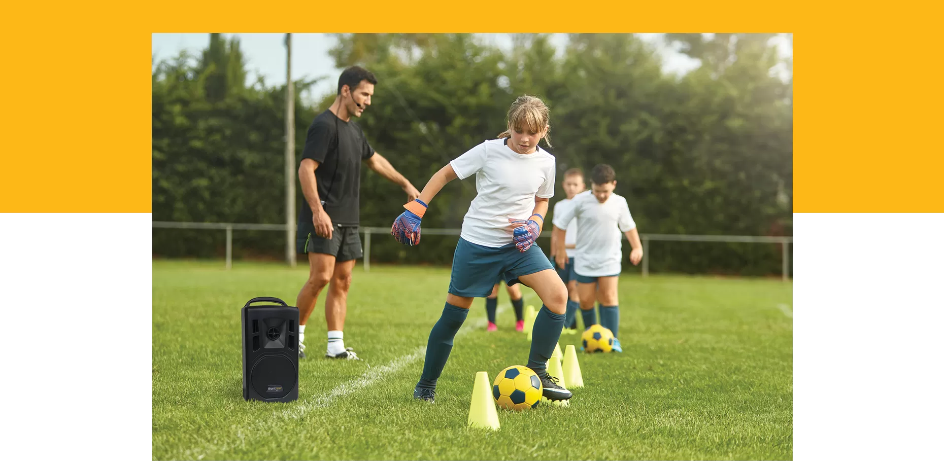 Outdoor sports class using a lyrik speaker. Yellow banner at top behind image