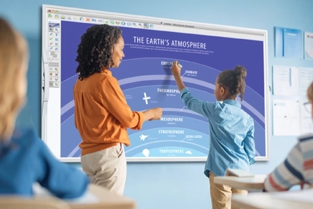 teacher helping student use a mimio teach