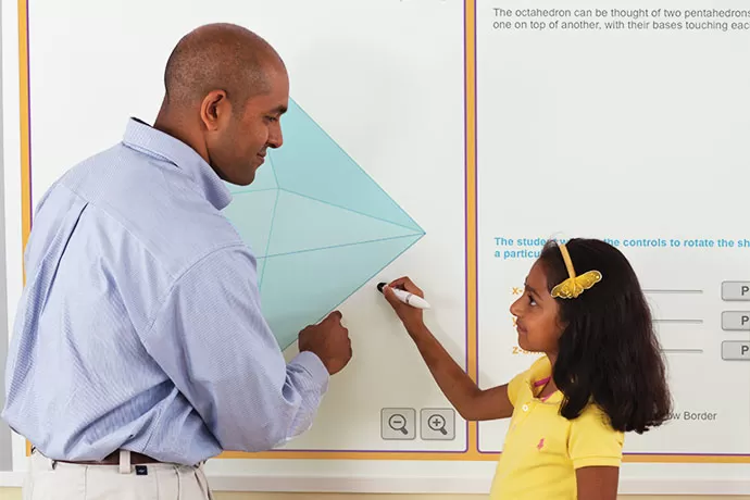 teacher helping student use a mimio board