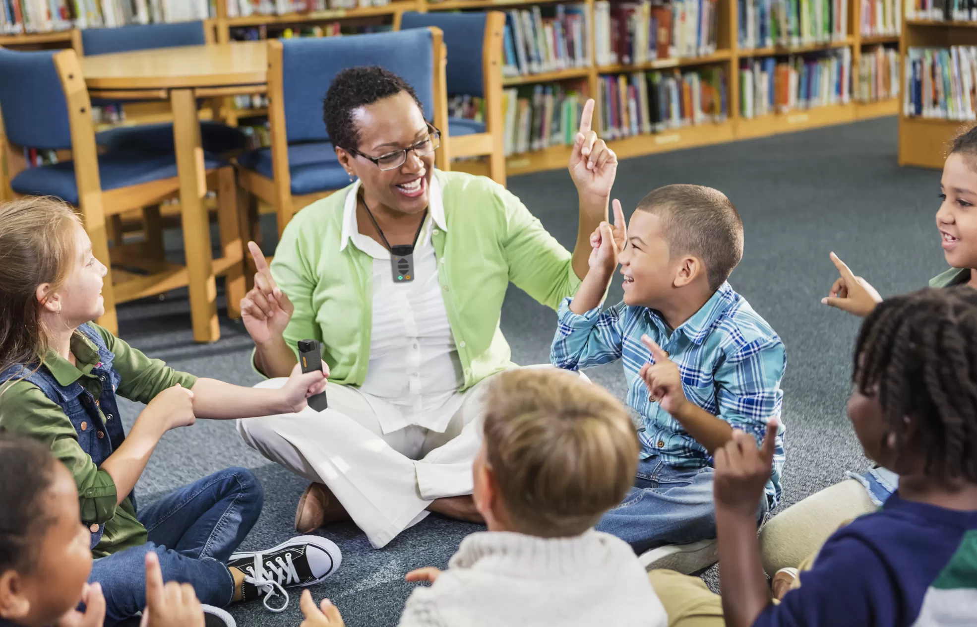 teacher using a wearable microphone and engaging with their class