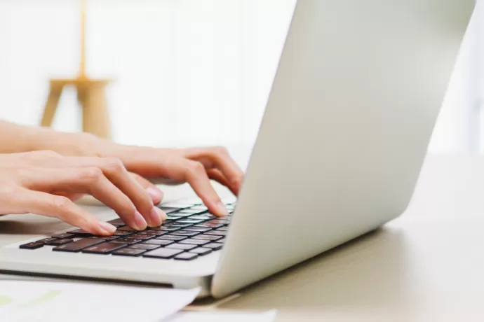 person typing on a laptop