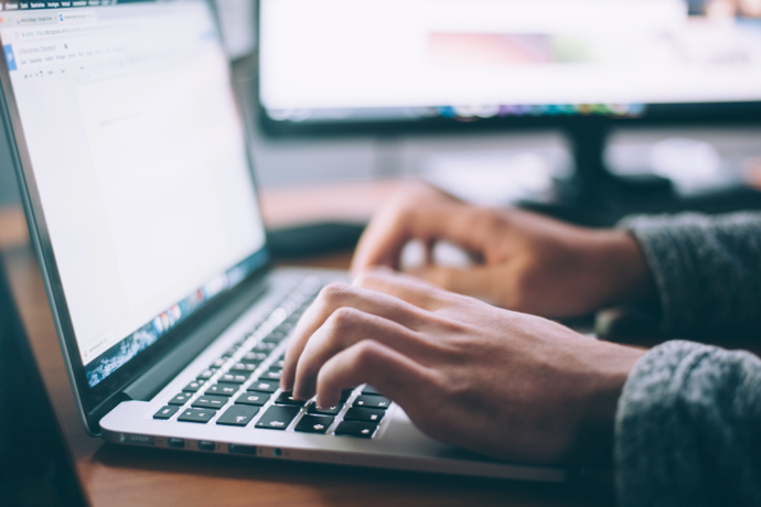 person typing on a laptop