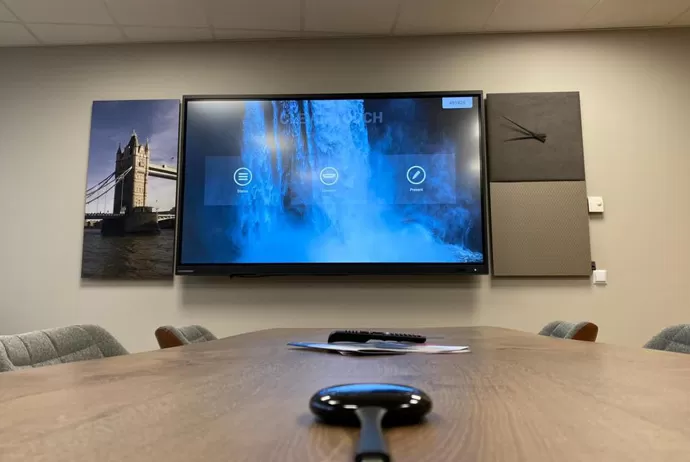large clevertouch screen in a meeting room with a dongle on the table
