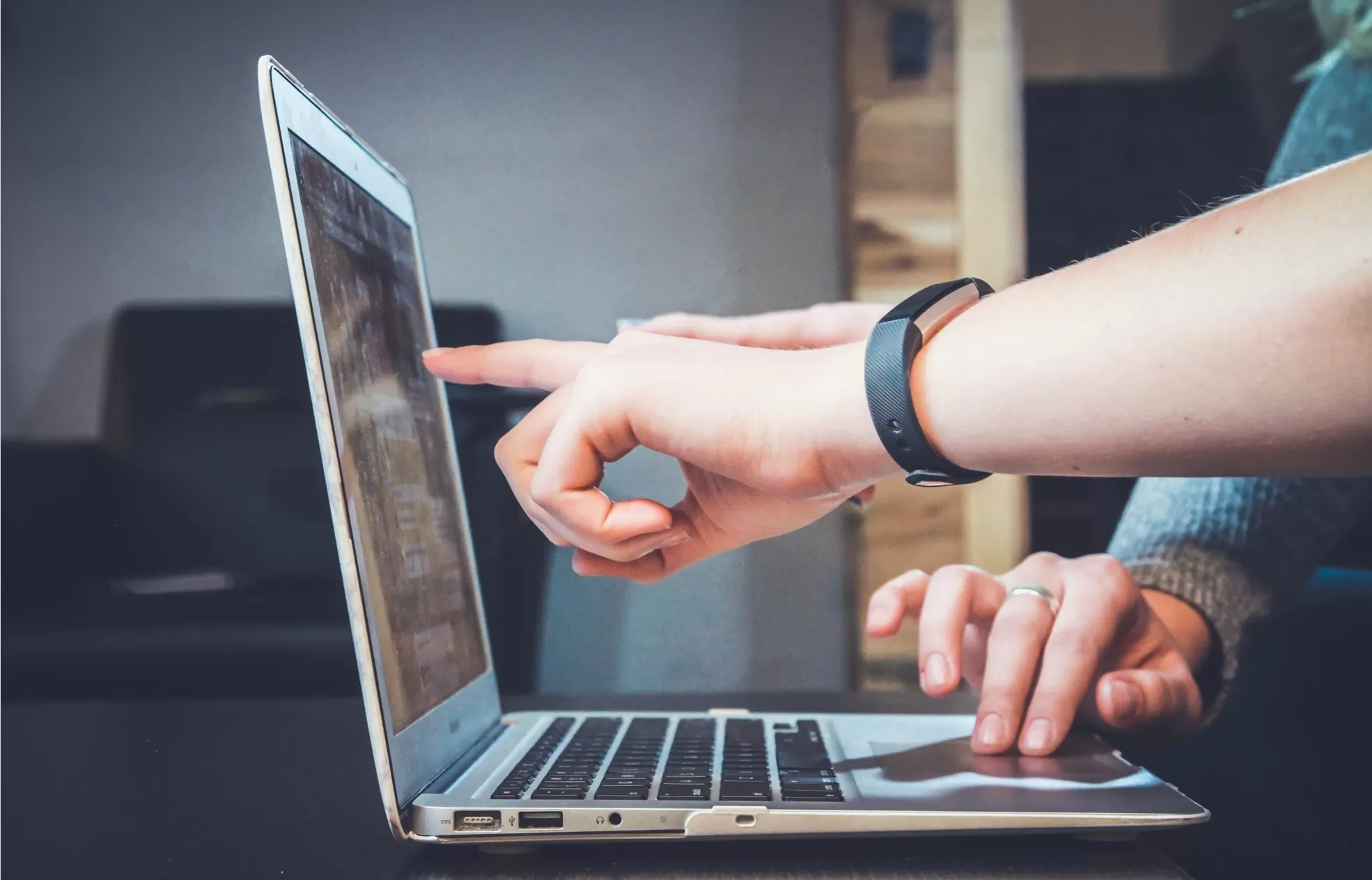 people pointing at a laptop