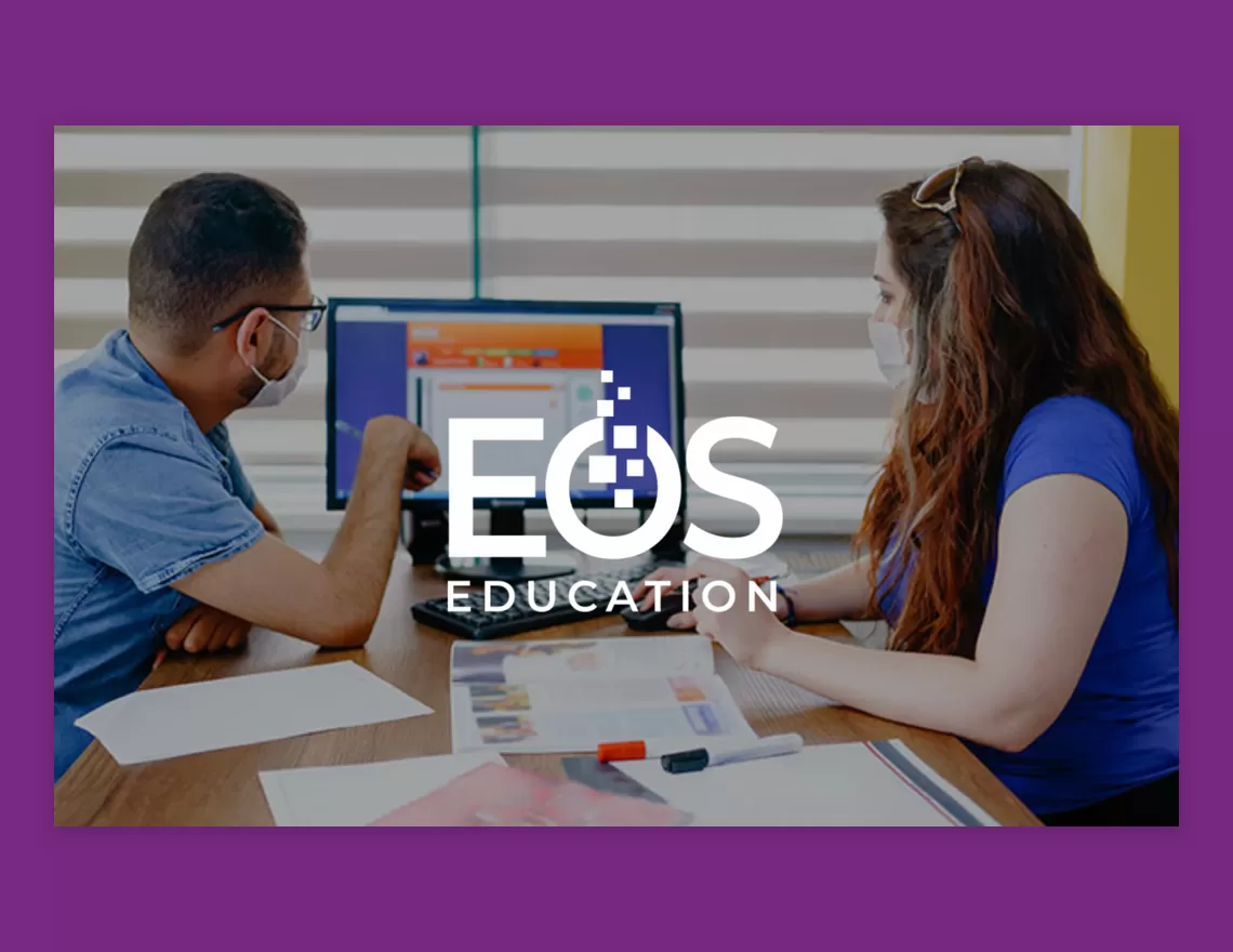 two people looking at a presentation in a purple box with EOS logo over the top