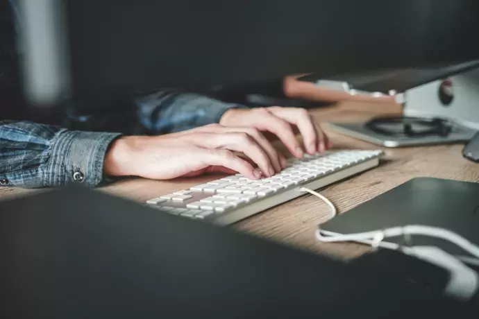 person typing on a keyboard