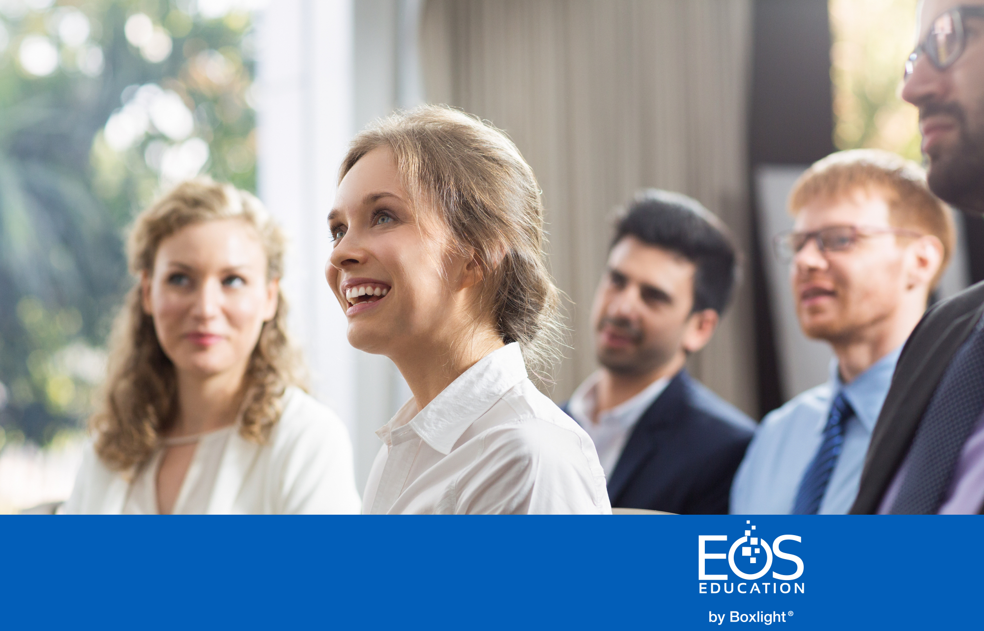 people smiling inn a seminar with a blue banner and the EOS logo along the bottom