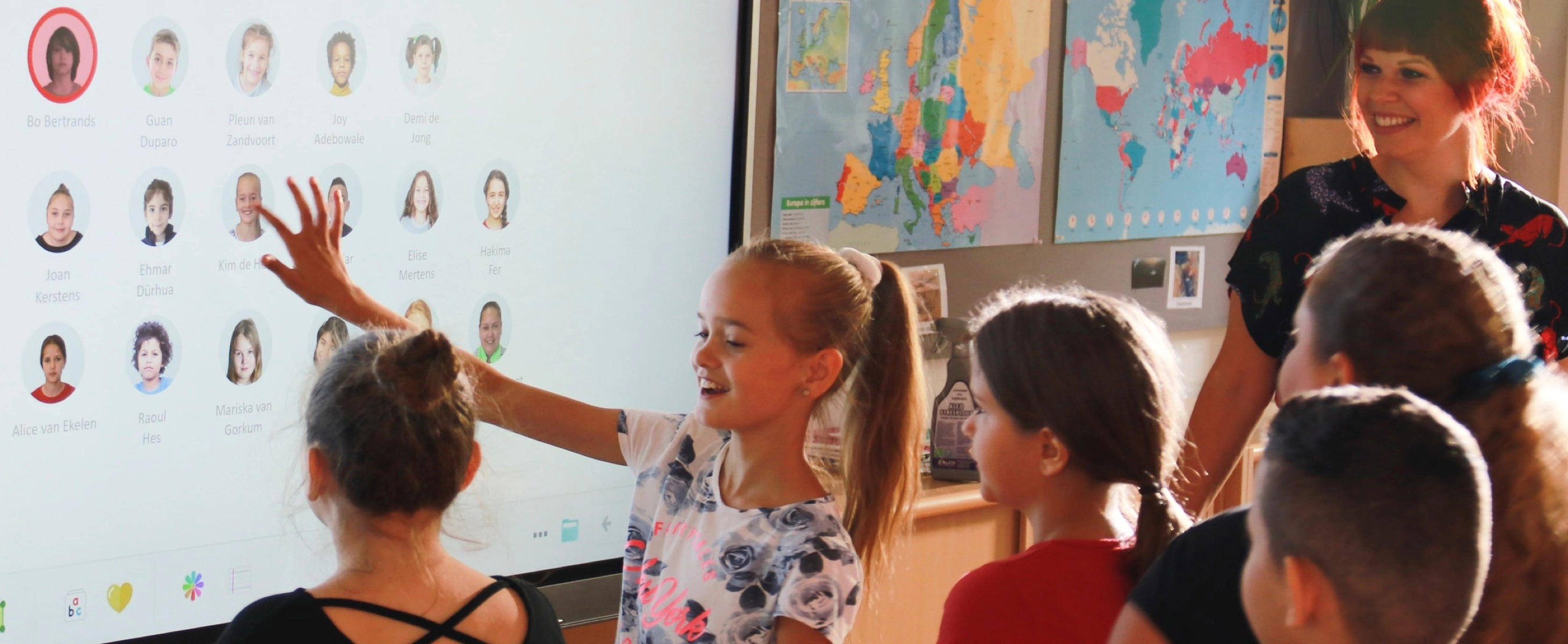 Students using a MimioPro 4 interactive display screen in a classroom